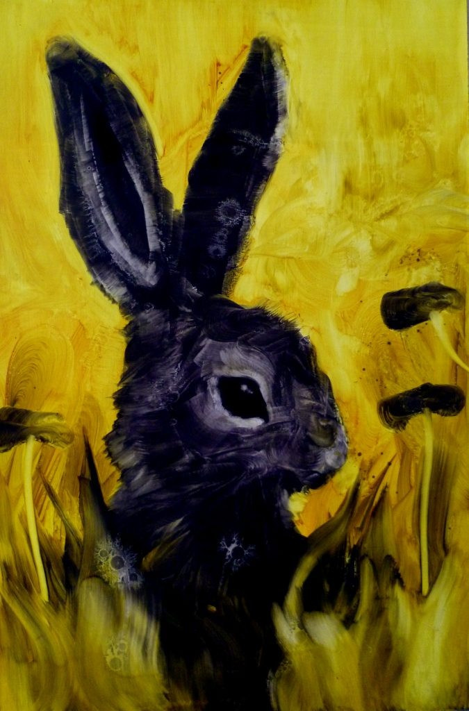 A large black rabbit sitting upright against an intense yellow field.